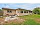 Cozy backyard featuring a stone patio with a fire pit and outdoor seating area at 2007 Mosher Dr, Orlando, FL 32810