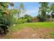 Large backyard with lush landscaping and view of pond; a nature lover's paradise at 2007 Mosher Dr, Orlando, FL 32810