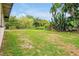 Expansive backyard with mature trees and lush lawn; perfect for outdoor activities at 2007 Mosher Dr, Orlando, FL 32810
