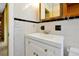 Bathroom featuring a white vanity, tiled walls, and a wood-framed mirror at 2007 Mosher Dr, Orlando, FL 32810