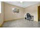 A simply decorated bedroom with neutral walls, terrazzo floors, and a ceiling fan at 2007 Mosher Dr, Orlando, FL 32810