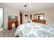 Bright bedroom featuring a large floral comforter, a TV, and plenty of storage space at 2007 Mosher Dr, Orlando, FL 32810