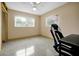 Bright bedroom featuring a ceiling fan, two windows, neutral walls and distinct terrazzo flooring at 2007 Mosher Dr, Orlando, FL 32810