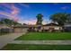 Charming ranch-style home with a well-manicured lawn, a two-car garage, and lush landscaping at 2007 Mosher Dr, Orlando, FL 32810