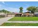Charming ranch-style home with a well-manicured lawn, a two-car garage, and lush landscaping at 2007 Mosher Dr, Orlando, FL 32810