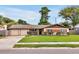 Charming single-story home with a manicured lawn, mature landscaping, and a two-car garage at 2007 Mosher Dr, Orlando, FL 32810