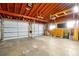 Spacious garage featuring multiple doors, high ceilings, and ample storage space at 2007 Mosher Dr, Orlando, FL 32810