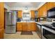 Charming kitchen with stainless steel appliances, patterned wallpaper, and ample cabinet space at 2007 Mosher Dr, Orlando, FL 32810