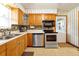 Traditional kitchen features stainless steel appliances, patterned wallpaper, and an exterior door at 2007 Mosher Dr, Orlando, FL 32810