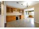 Bright living room with built-in cabinetry, tile floors, and a view to the backyard at 2007 Mosher Dr, Orlando, FL 32810