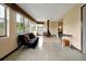 Bright living room with polished floors, a futon, large windows, and a modern free-standing fireplace at 2007 Mosher Dr, Orlando, FL 32810