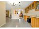 Open-concept living room featuring tile floors, cabinets, and a view into the kitchen at 2007 Mosher Dr, Orlando, FL 32810