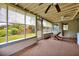 Relaxing screened porch features ceiling fan and view of lush green backyard at 2007 Mosher Dr, Orlando, FL 32810