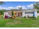 Spacious backyard with a playset and mature trees offering plenty of shade at 2022 Edgewood Rd, Leesburg, FL 34748
