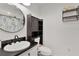 Bathroom features a modern vanity, updated fixtures, and an elegant sliding door cabinet at 2022 Edgewood Rd, Leesburg, FL 34748