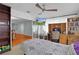 Cozy bedroom featuring a ceiling fan, built-in shelves, and a TV to create a relaxing retreat at 2022 Edgewood Rd, Leesburg, FL 34748