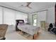 This bedroom is naturally lit with big windows and sliding glass doors to access the backyard at 2022 Edgewood Rd, Leesburg, FL 34748