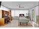 Bright bedroom features a ceiling fan, a work station with built-in shelves, and sliding glass door at 2022 Edgewood Rd, Leesburg, FL 34748