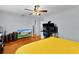 Spacious bedroom featuring hardwood floors, a ceiling fan, and a work space at 2022 Edgewood Rd, Leesburg, FL 34748