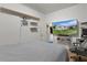 A simple carpeted bedroom with shelving and a TV for relaxing and entertaining at 2022 Edgewood Rd, Leesburg, FL 34748