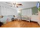 Charming Bedroom with hardwood floors, crib, dresser, and soothing green walls for a serene space at 2022 Edgewood Rd, Leesburg, FL 34748