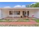 Inviting front porch with decorative ironwork and brick accents, providing a charming entrance to the home at 2022 Edgewood Rd, Leesburg, FL 34748