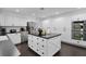 Modern kitchen features a large island with white cabinets and stainless-steel appliances at 2022 Edgewood Rd, Leesburg, FL 34748