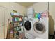 Functional laundry room features modern appliances, shelving, and ample space for organization at 2022 Edgewood Rd, Leesburg, FL 34748