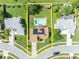 Aerial view of a property with a backyard pool and solar panels on the roof at 2104 Winding Ridge S Ave, Kissimmee, FL 34741