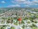 Aerial view of a residential neighborhood highlighting a specific property with a red pin marker at 2104 Winding Ridge S Ave, Kissimmee, FL 34741