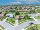 Aerial view of a residential neighborhood featuring a house with a well-manicured lawn at 2104 Winding Ridge S Ave, Kissimmee, FL 34741