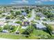 Aerial view of a residential neighborhood featuring a house with solar panels and a pool at 2104 Winding Ridge S Ave, Kissimmee, FL 34741