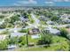 Aerial view of a residential neighborhood featuring a house with solar panels and a pool at 2104 Winding Ridge S Ave, Kissimmee, FL 34741