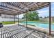 Backyard showcasing a pergola, well-maintained pool, and a spacious grassy area at 2104 Winding Ridge S Ave, Kissimmee, FL 34741