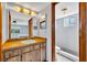 Bathroom with a single vanity, shower, toilet, and access to the primary bedroom at 2104 Winding Ridge S Ave, Kissimmee, FL 34741