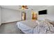 Bright bedroom featuring neutral walls, carpet, ceiling fan and entrance to the bathroom at 2104 Winding Ridge S Ave, Kissimmee, FL 34741