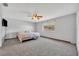 Spacious bedroom features carpet, a window providing natural light, and a ceiling fan at 2104 Winding Ridge S Ave, Kissimmee, FL 34741