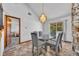 Stylish dining area with modern chandelier, and view to bedroom and stone accents creating an inviting atmosphere at 2104 Winding Ridge S Ave, Kissimmee, FL 34741