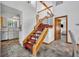 Sunlit Entryway features carpeted stairs leading up and the kitchen off to the left at 2104 Winding Ridge S Ave, Kissimmee, FL 34741
