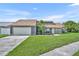Charming single-Gathering home featuring a two-car garage, well-maintained lawn and beautiful landscaping at 2104 Winding Ridge S Ave, Kissimmee, FL 34741