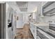 Bright kitchen featuring stainless steel appliances and tiled floors leading to the dining room at 2104 Winding Ridge S Ave, Kissimmee, FL 34741