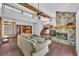 Open concept living area features tile floors, stone fireplace, wood beams, and natural light from clerestory windows at 2104 Winding Ridge S Ave, Kissimmee, FL 34741