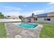 Backyard view of pool with solar panels and fencing offering both sustainability and privacy at 2104 Winding Ridge S Ave, Kissimmee, FL 34741