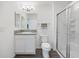 Well-lit bathroom featuring a modern vanity, commode, and a shower with sliding glass doors at 2142 Weber Ct, The Villages, FL 32163