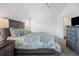 Bedroom featuring a bed, ceiling fan, nightstands and dresser with TV at 2142 Weber Ct, The Villages, FL 32163