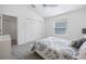 Bedroom with gray carpet, ceiling fan, white walls, and large window at 2142 Weber Ct, The Villages, FL 32163