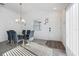 Bright dining area with modern chandelier, stylish table, and chairs, adjacent to the front entrance at 2142 Weber Ct, The Villages, FL 32163
