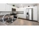Well-equipped kitchen featuring white cabinets, stainless steel appliances, and modern countertops at 2142 Weber Ct, The Villages, FL 32163