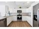 Bright kitchen featuring stainless steel appliances, sleek countertops, and plenty of cabinet space at 2142 Weber Ct, The Villages, FL 32163