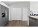 Spacious kitchen with stainless steel refrigerator and wood-look floors, next to laundry closet and dining room at 2142 Weber Ct, The Villages, FL 32163